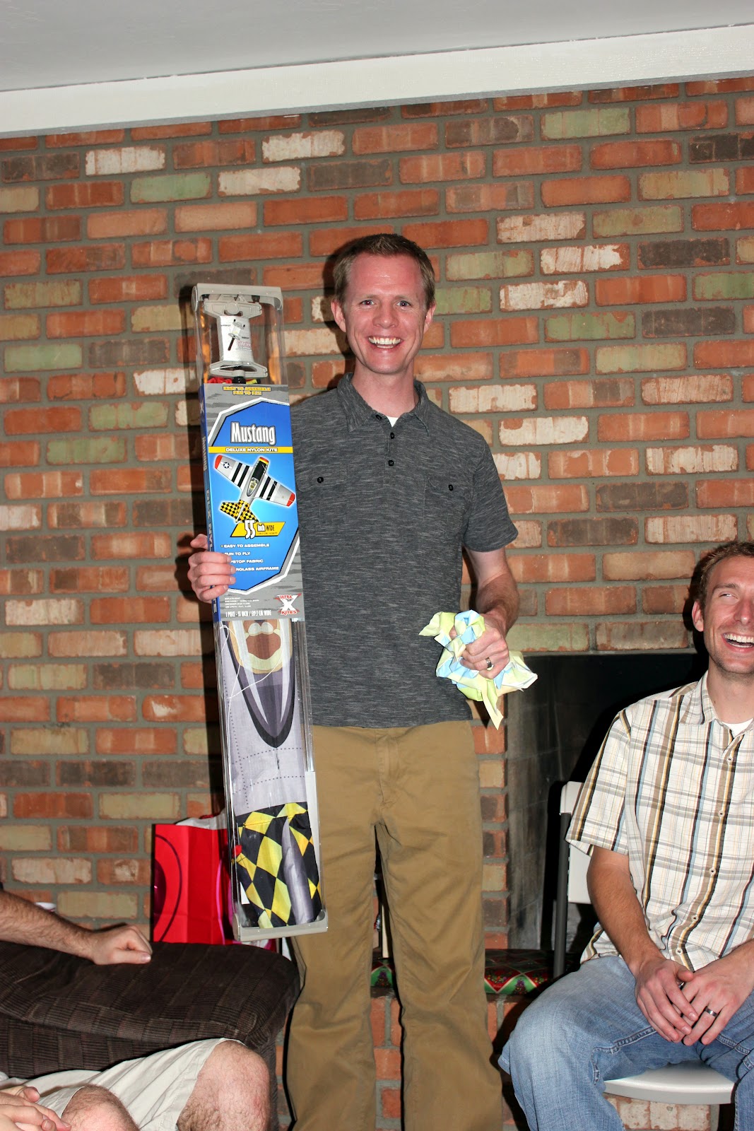 Man holding a child\'s kite received as a bad wedding present. 