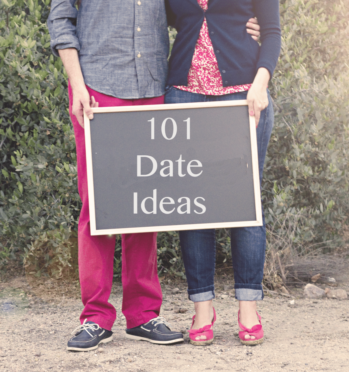 Couple holding a 101 Date Ideas sign. 