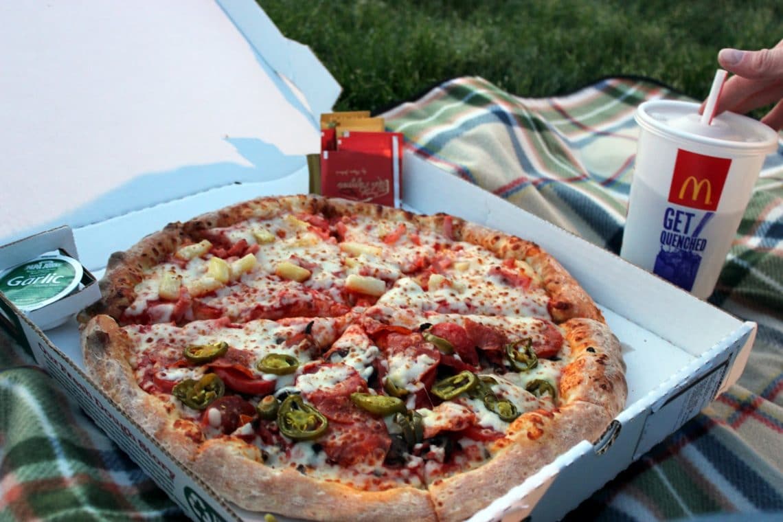 Takeout pizza with pizza box open. 