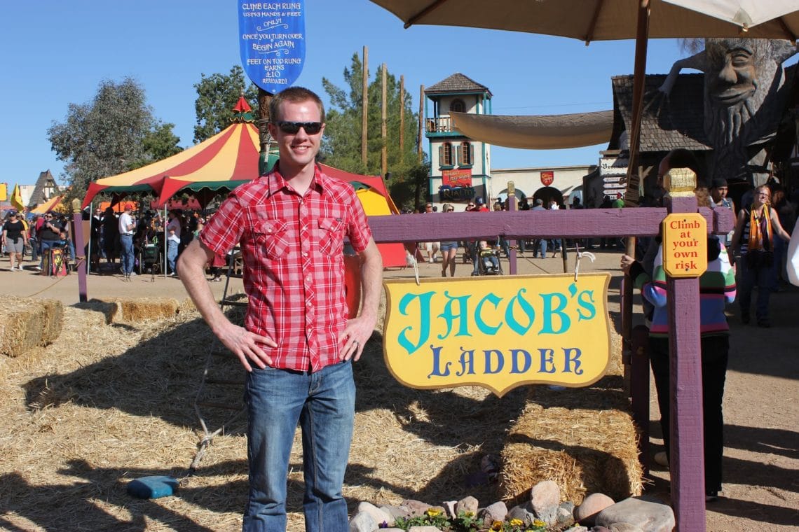 A man standing in front of Jacob\'s Ladder the Renaissance Festival in Arizona. 