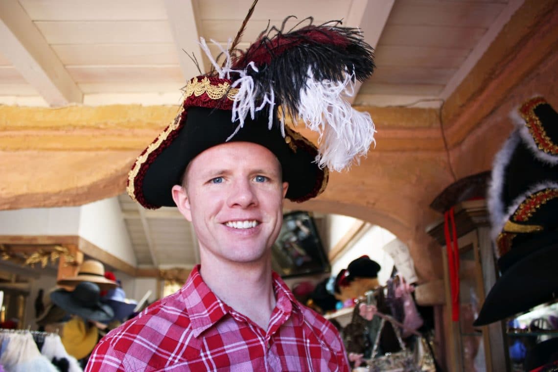 A man modeling a hat for sale at the Renaissance Festival in Arizona. 