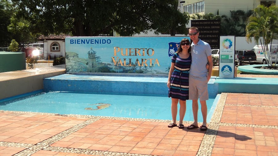 Couple in front of Puerto Vallarta sign. 