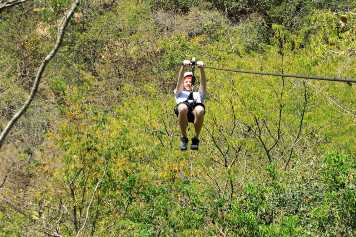 Man Zip-lining in Puerta Vallarta Mexico. 