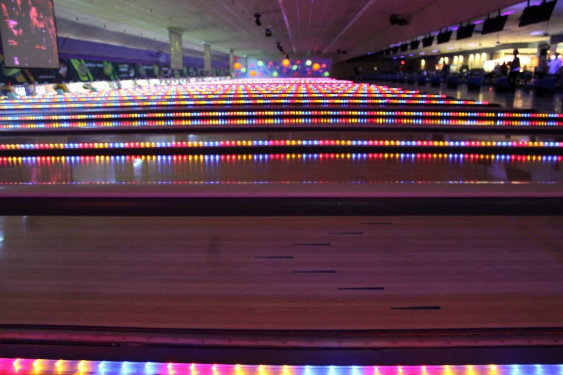 Bowling alley lit up for cosmic bowling. 
