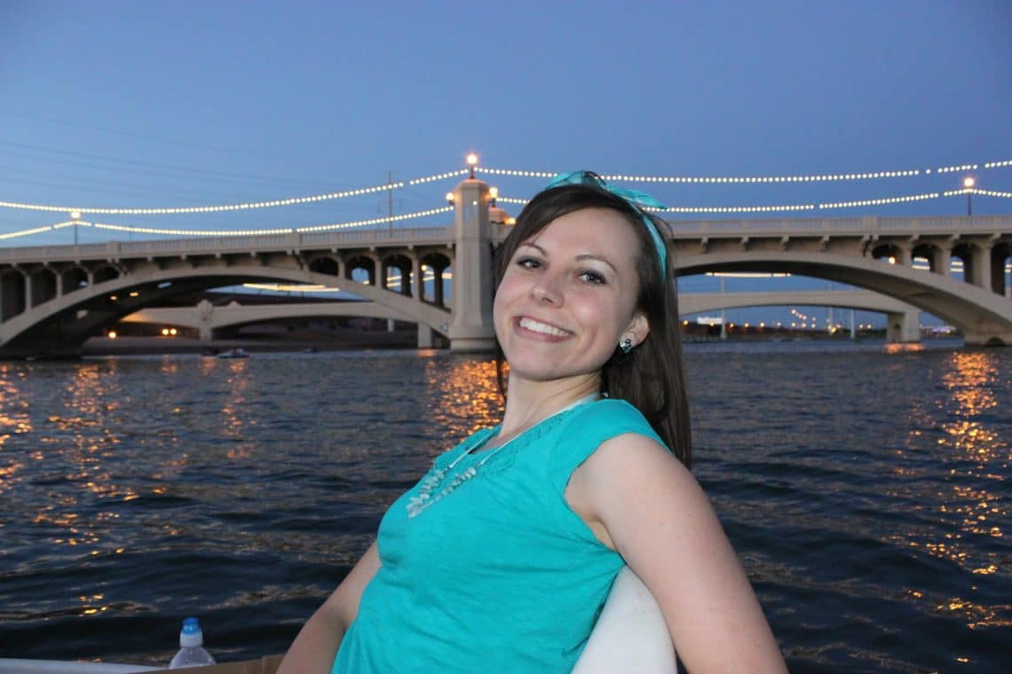 Woman using Paddle Boats Downtown with night sky and city lights behind her. 