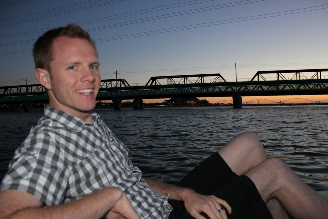 A man sitting on Paddleboats for date night watching the sun set. 