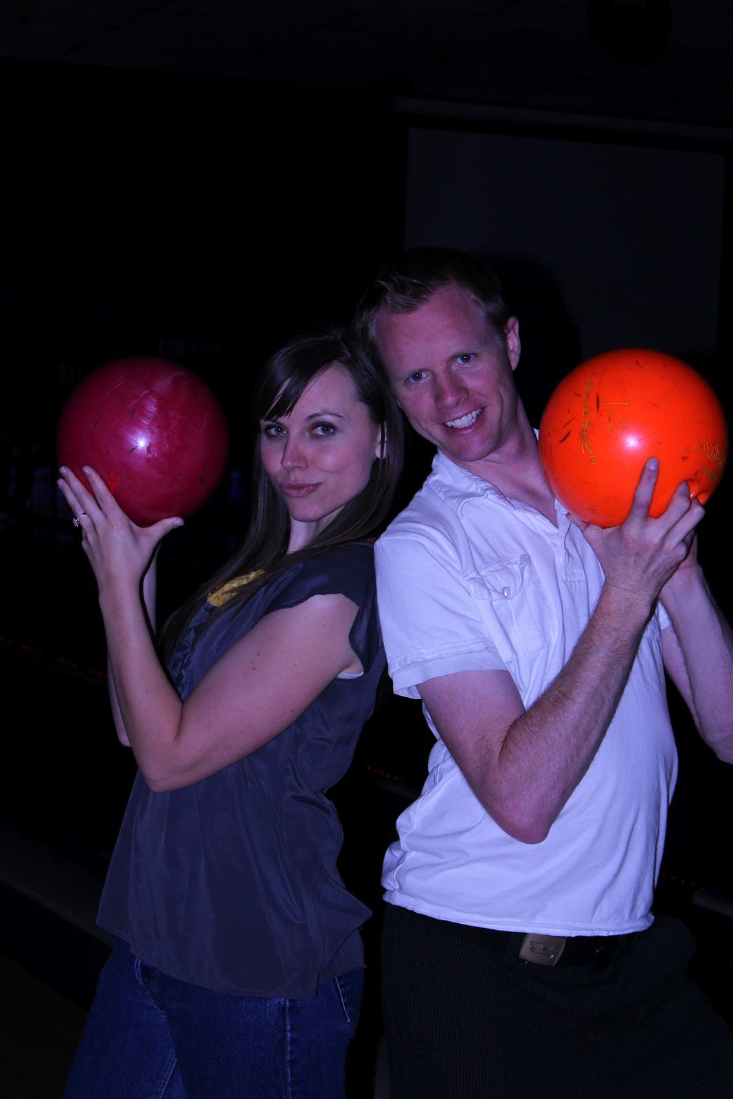 A couple on a bowling date night ready to play bowling with a twist. 