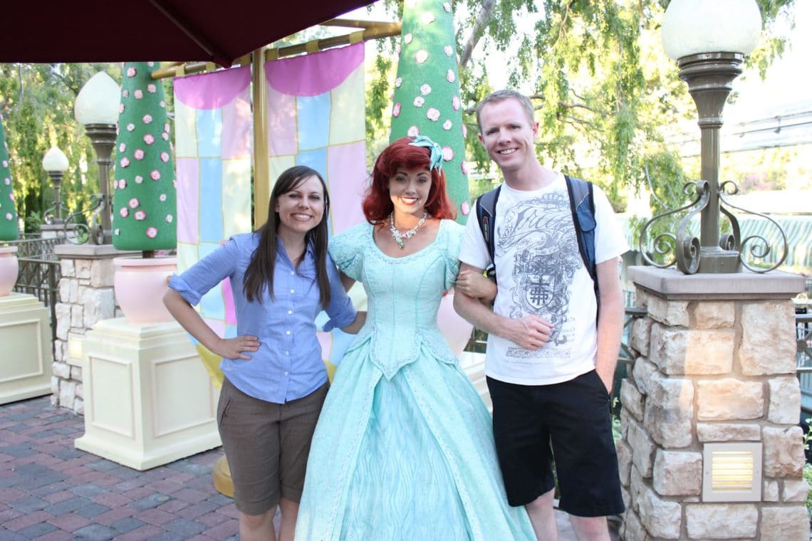 Disneyland date: couple in front of Disneyland castle. 