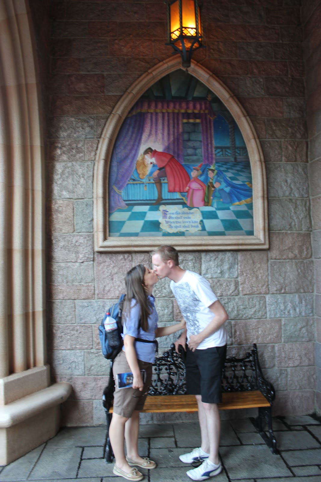 Disneyland date: couple in front of Disneyland castle. 