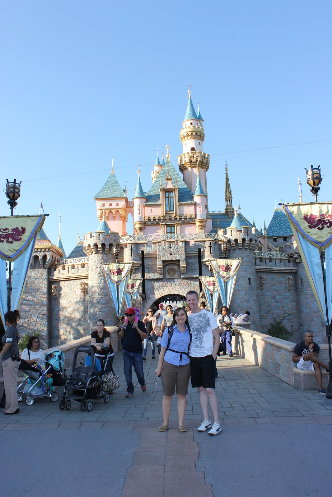 Disneyland date: couple in front of Disneyland castle. 