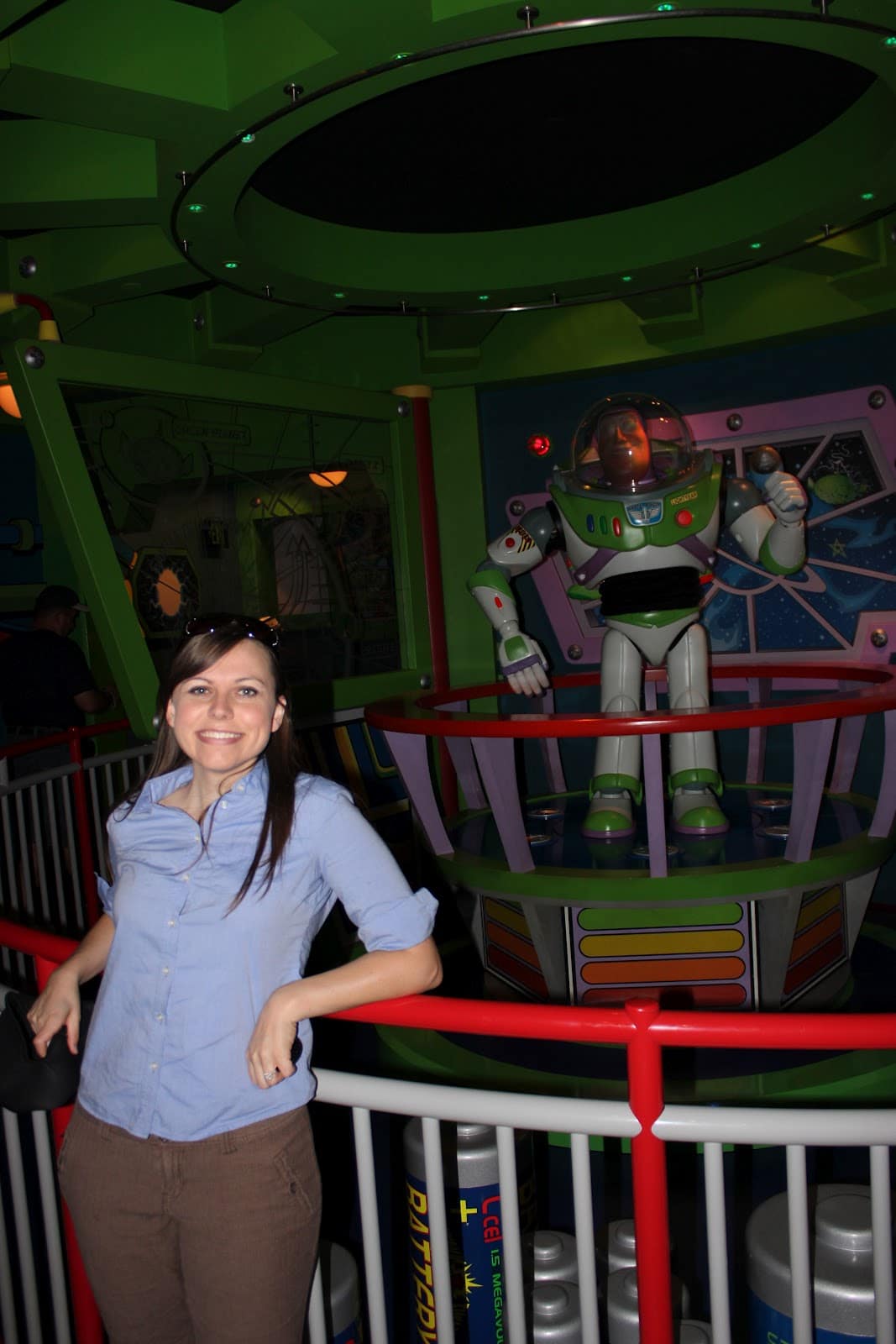 Disneyland date for couples in front of Buzz Lightyear. 