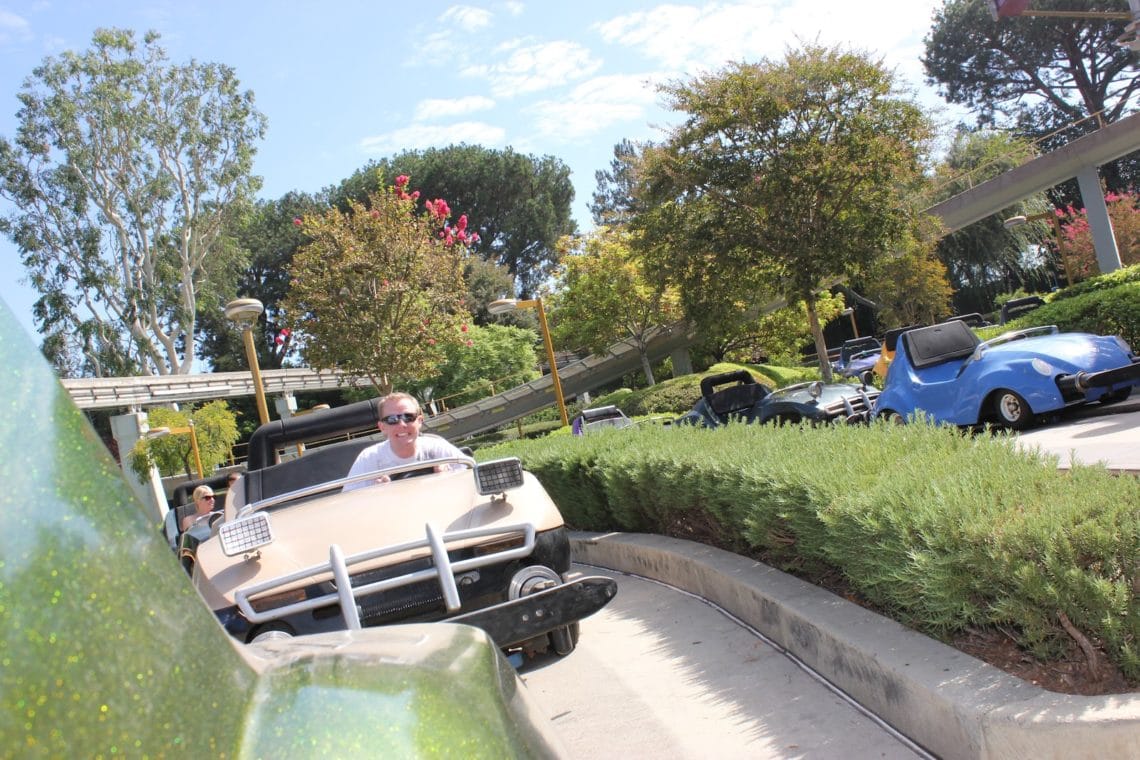 Disneyland date for couples riding Autotopia. 