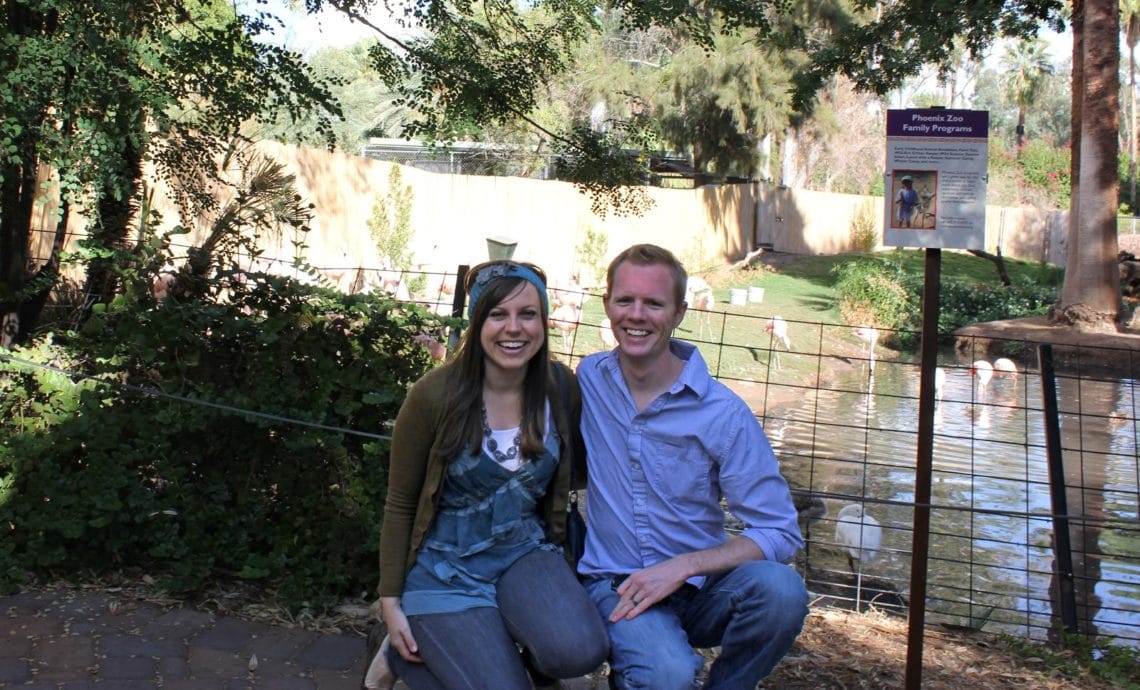 Couple looking at animals on a zoo date. 