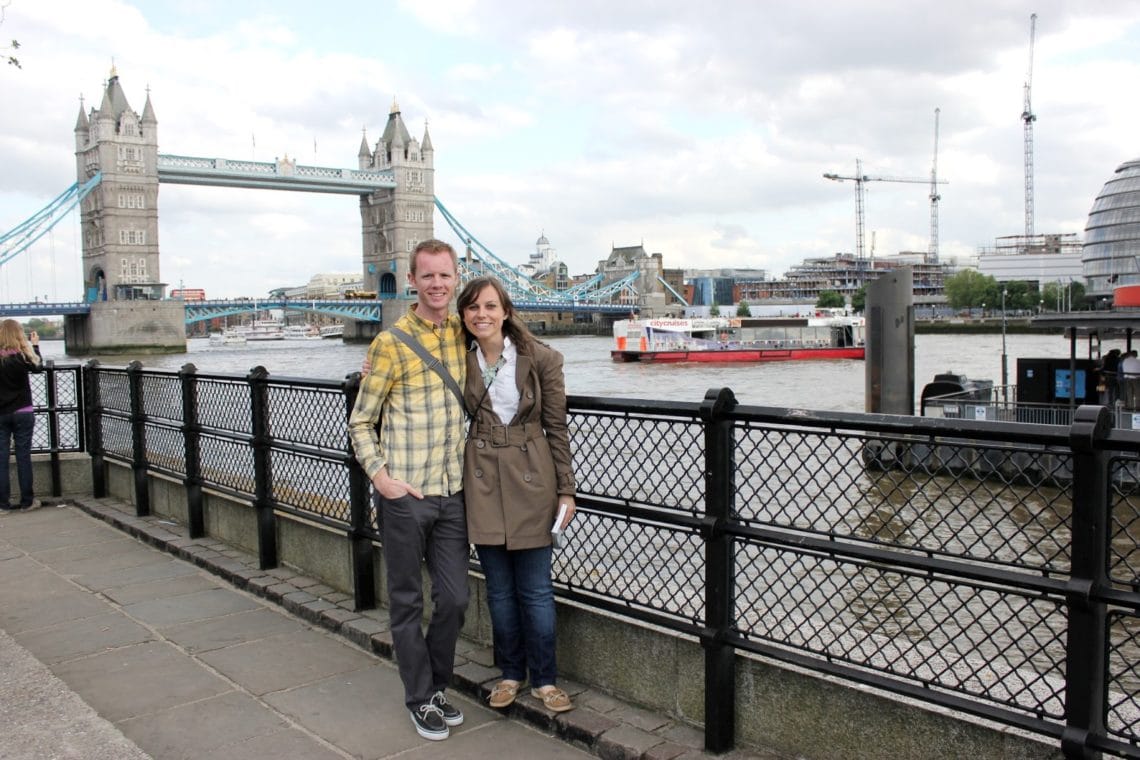 Couple standing in front of the Tower Bridge London. 