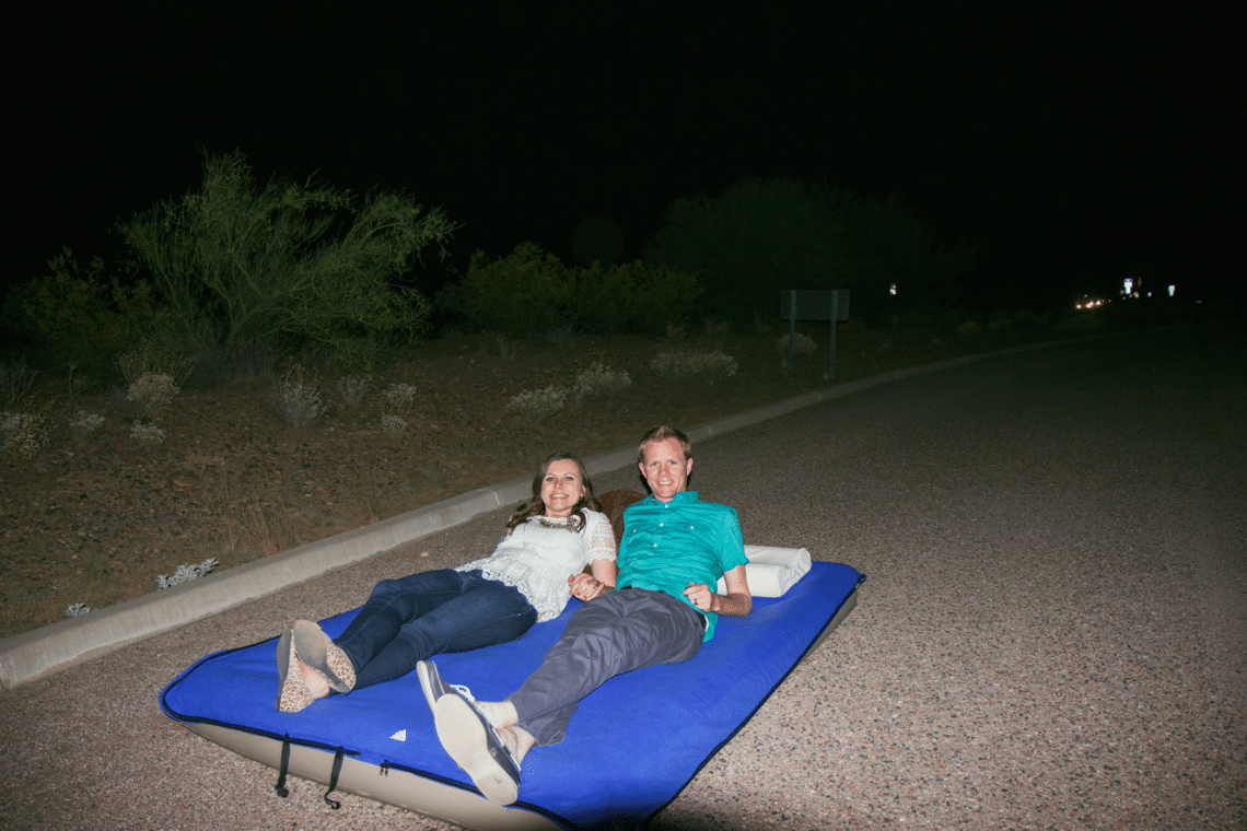 Stargazing date night with couple looking up at the stars. 