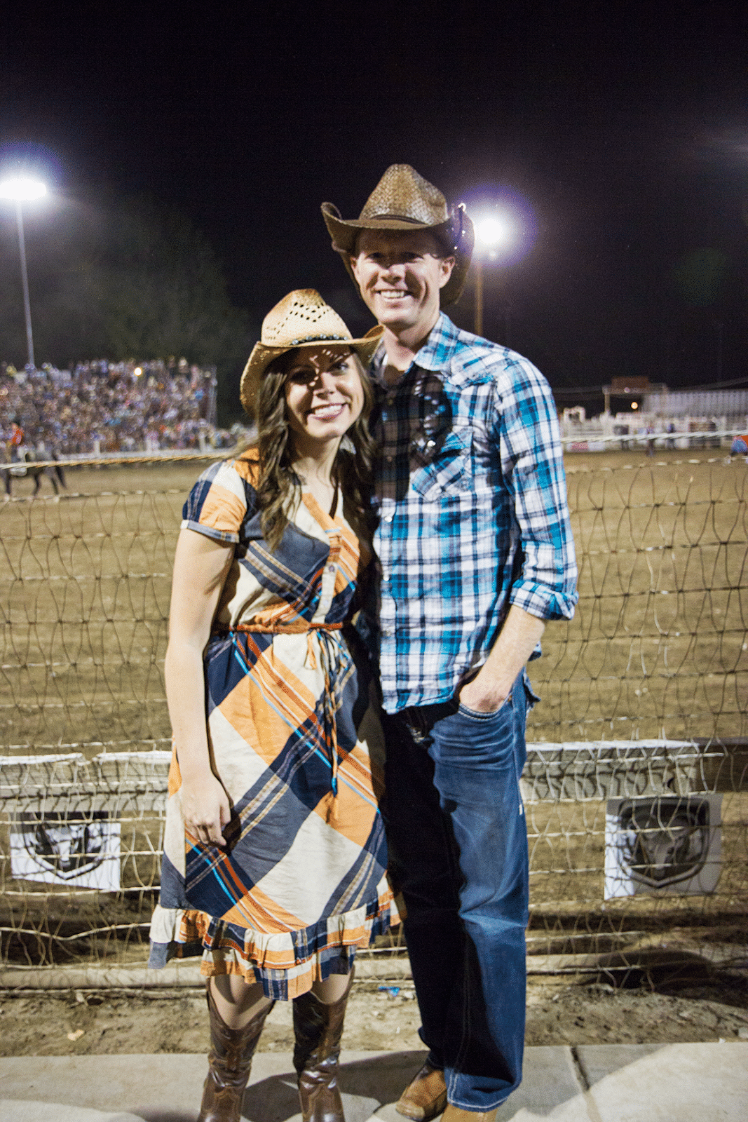 Couple in cowboy hats out on a rodeo date. 