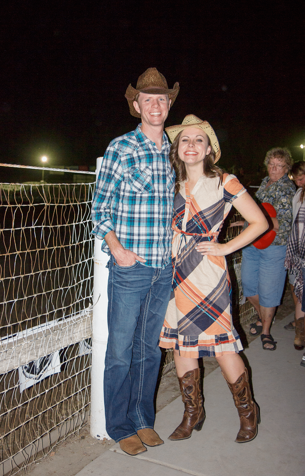 Rodeo Date Night couple in cowboy hats attending the rodeo for a date night. 