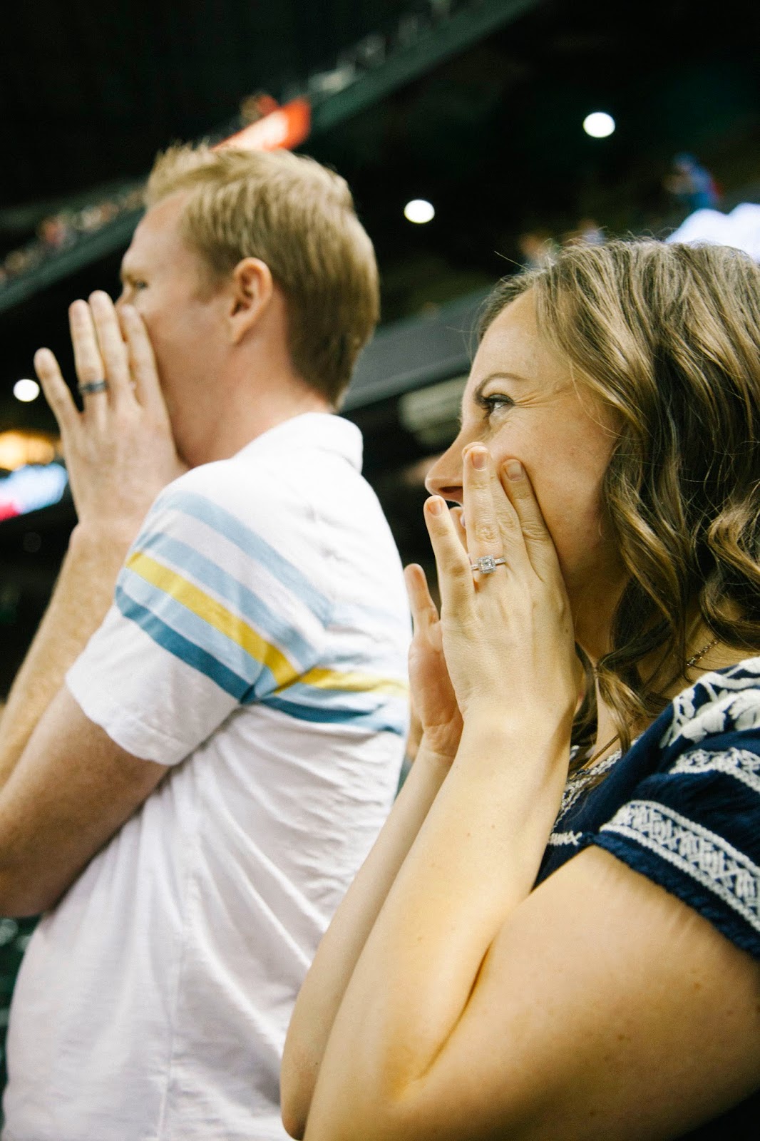 A couple enjoying baseball cheers during a Baseball date night. 