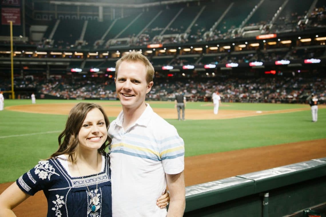 A couple down on the first row about to enjoy a baseball date night. 