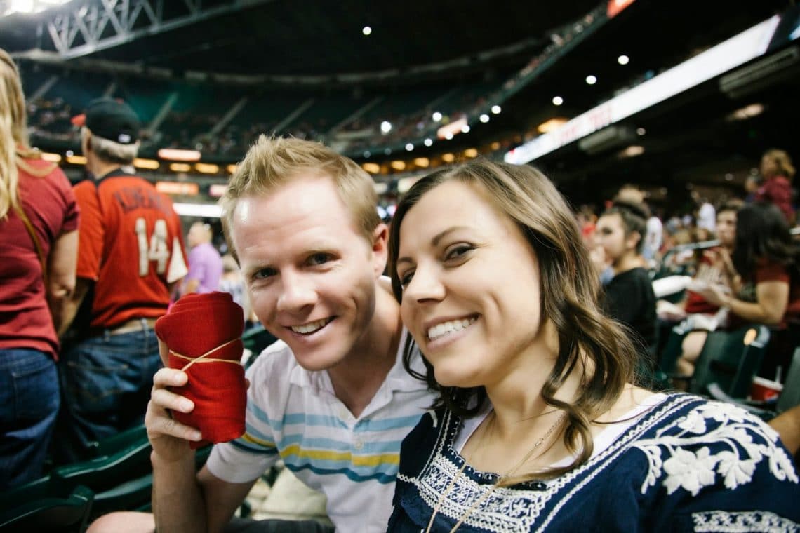 A couple after they caught free shirts during a Baseball date night. 