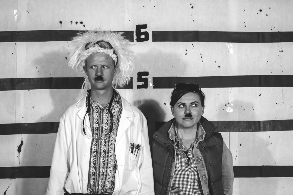 Couple in charlie chapman mustaches on Halloween. 