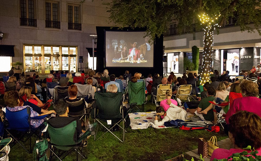 People on the grass at the Biltmore Movies in the Park night. 