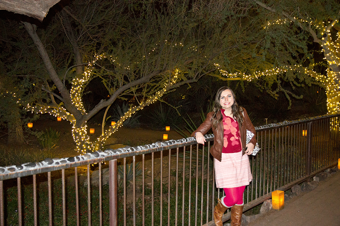 Woman in front of lights at Las Noches de Las Luminarias at the Desert Botanical Gardens. 