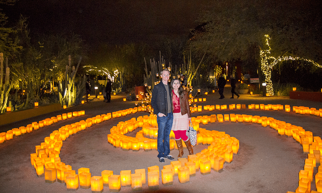 A couple in front of the lights at Las Noches de Las Luminarias at the Desert Botanical Gardens. 