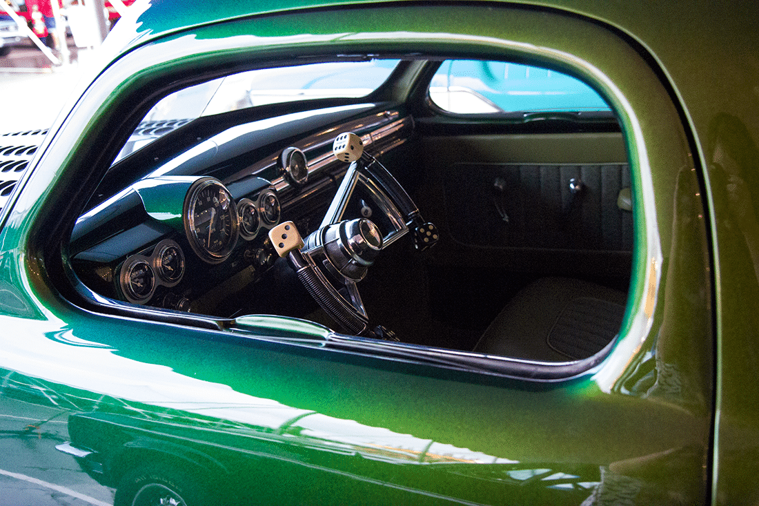 A green car at the Barrett Jackson auto show. 