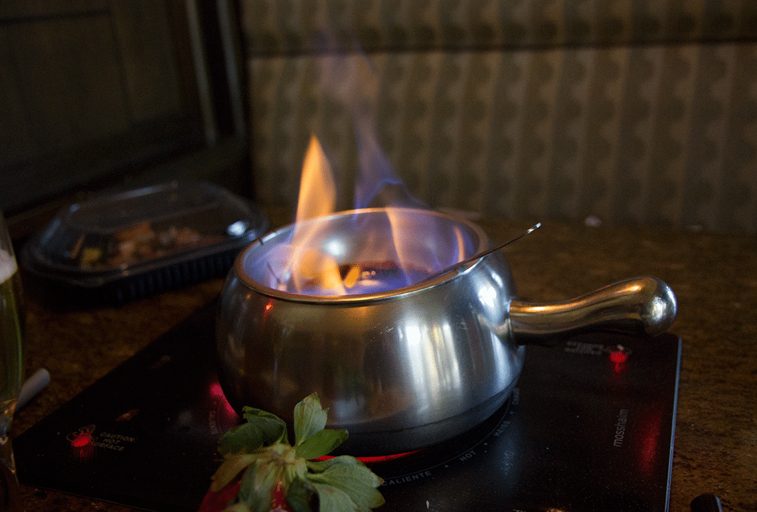 Melting Pot fondue with flame. 