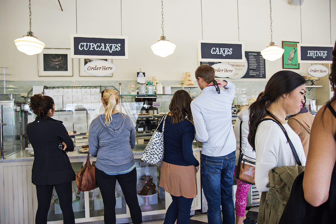 A couple choosing what to order during a Hollywood Cupcake Tour. 