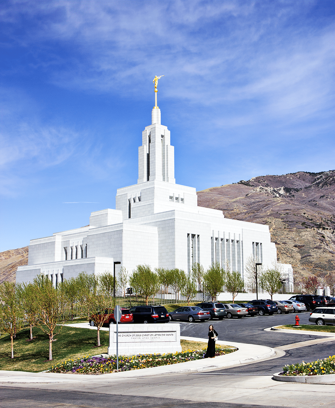 Standing next to The Draper Utah Temple sign wtih temple in the background. 