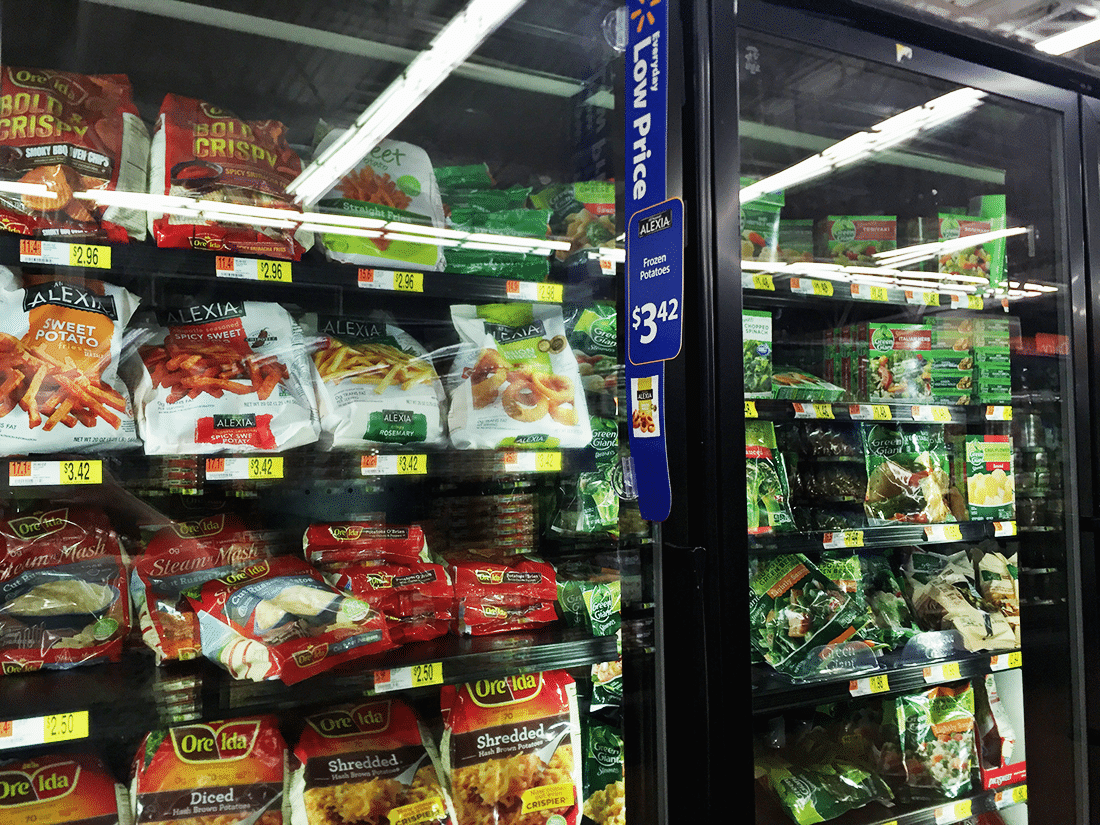 Grocery store freezer with sweet potato fries. 