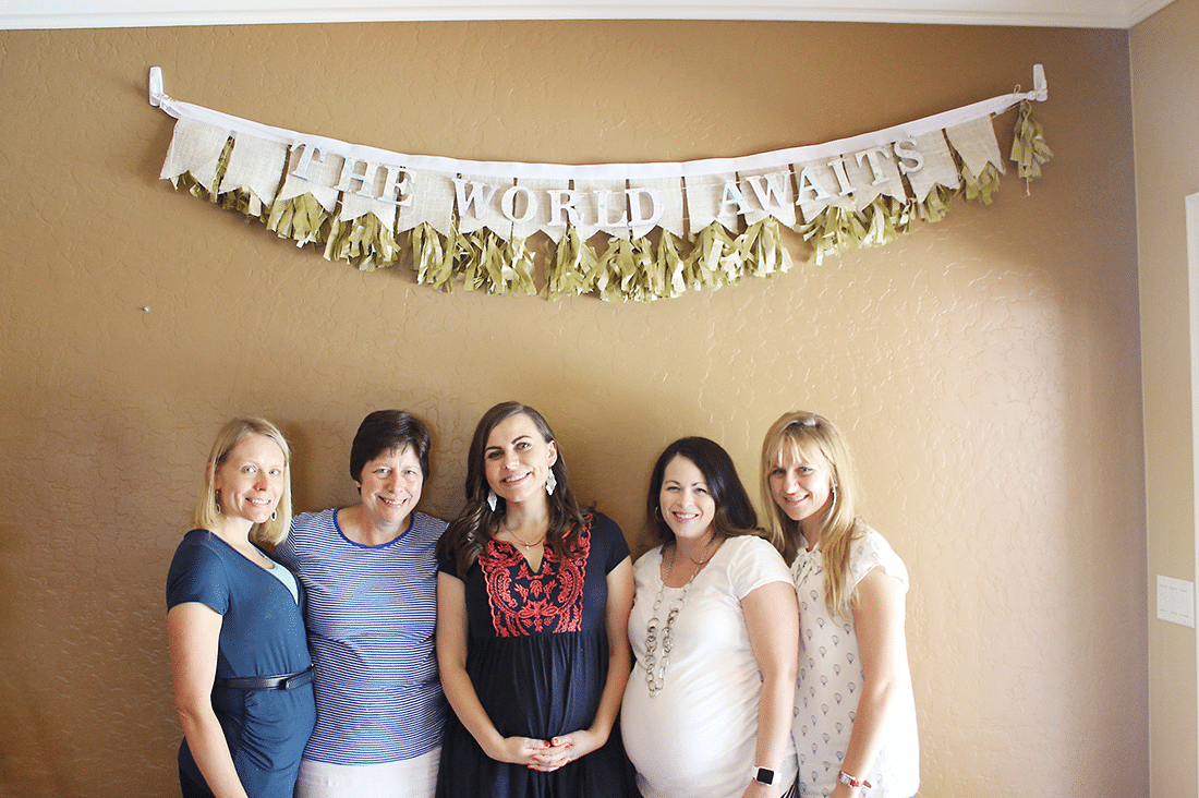 Welcome to the world baby shower expecting mom with hosts. 