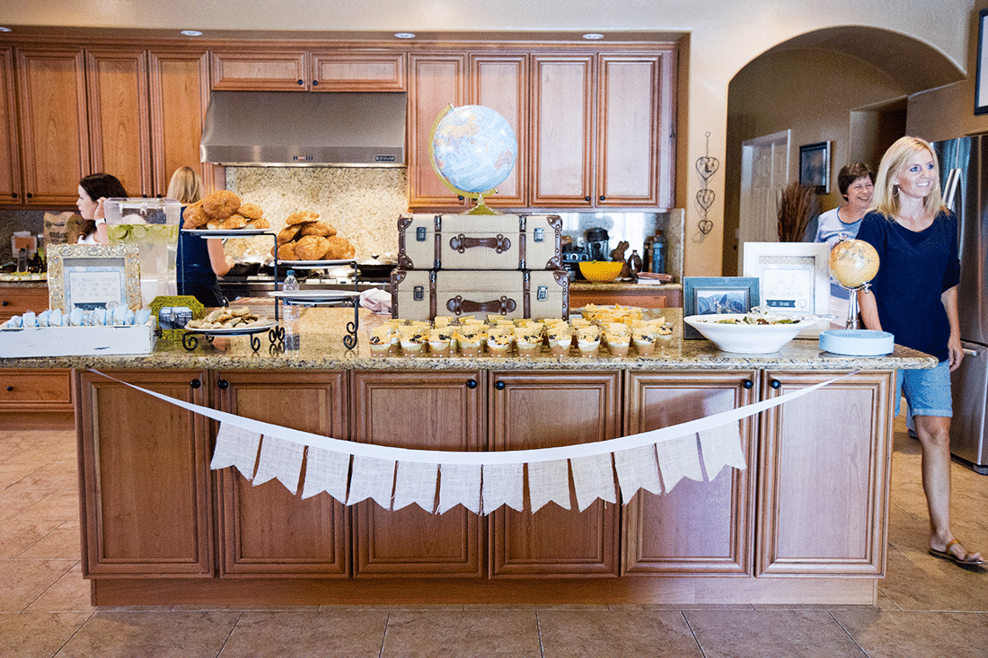 Welcome to the world baby shower tablescape with decorations and food. 