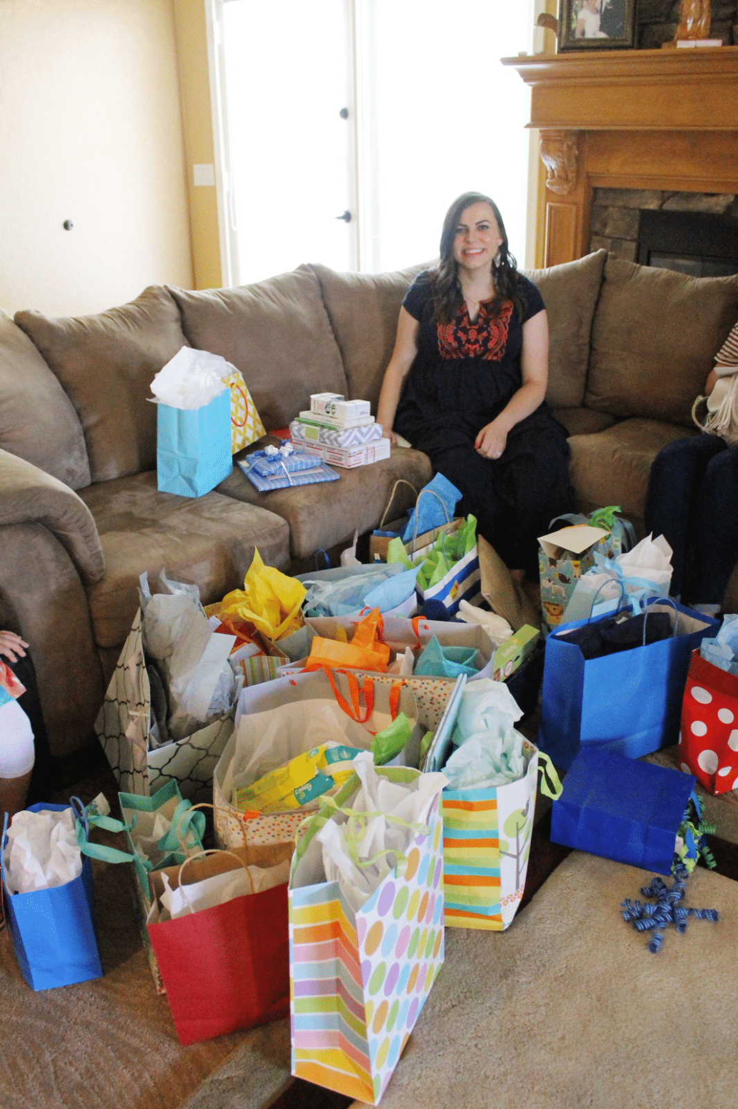 Welcome to the world baby shower mom with pile of presents. 