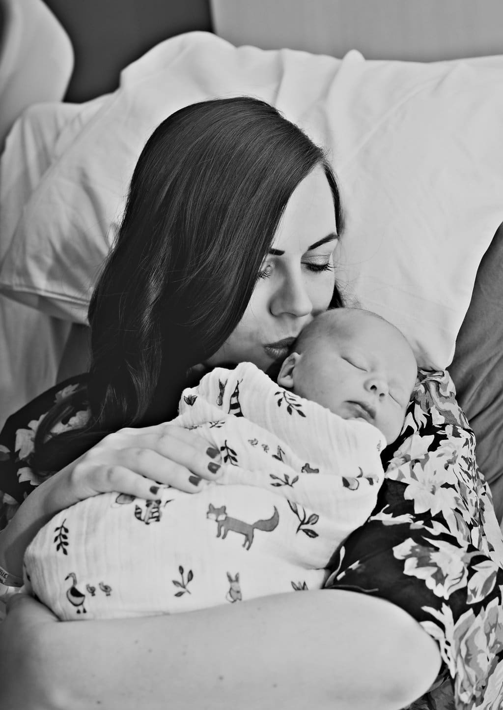 New mother pictures: mom kissing the newborn baby birth story photography. 