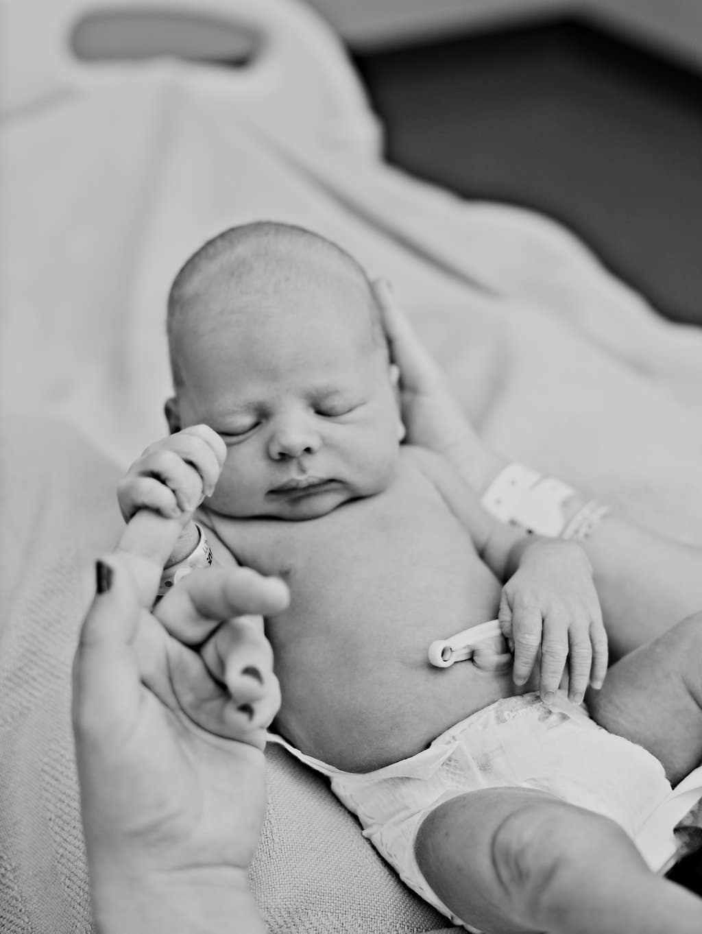 A Birth Story in Photos show newborn baby with freshly cut umbilical cord. 