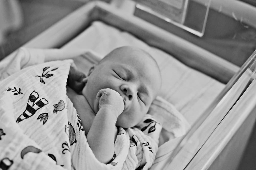 Birth Story Photography capturing a newborn baby in their hospital bassinet. 
