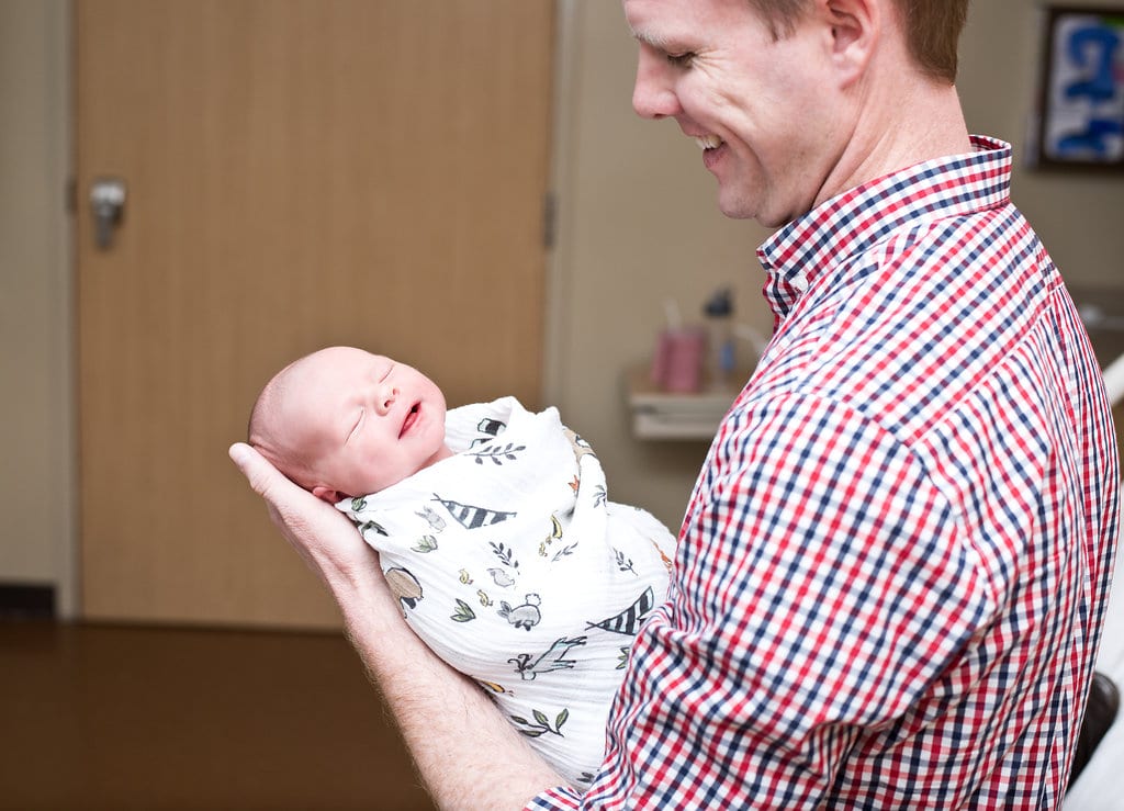 Newborn Hospital Photo Session: Capture the moment baby and new daddy fall in love with each other. 