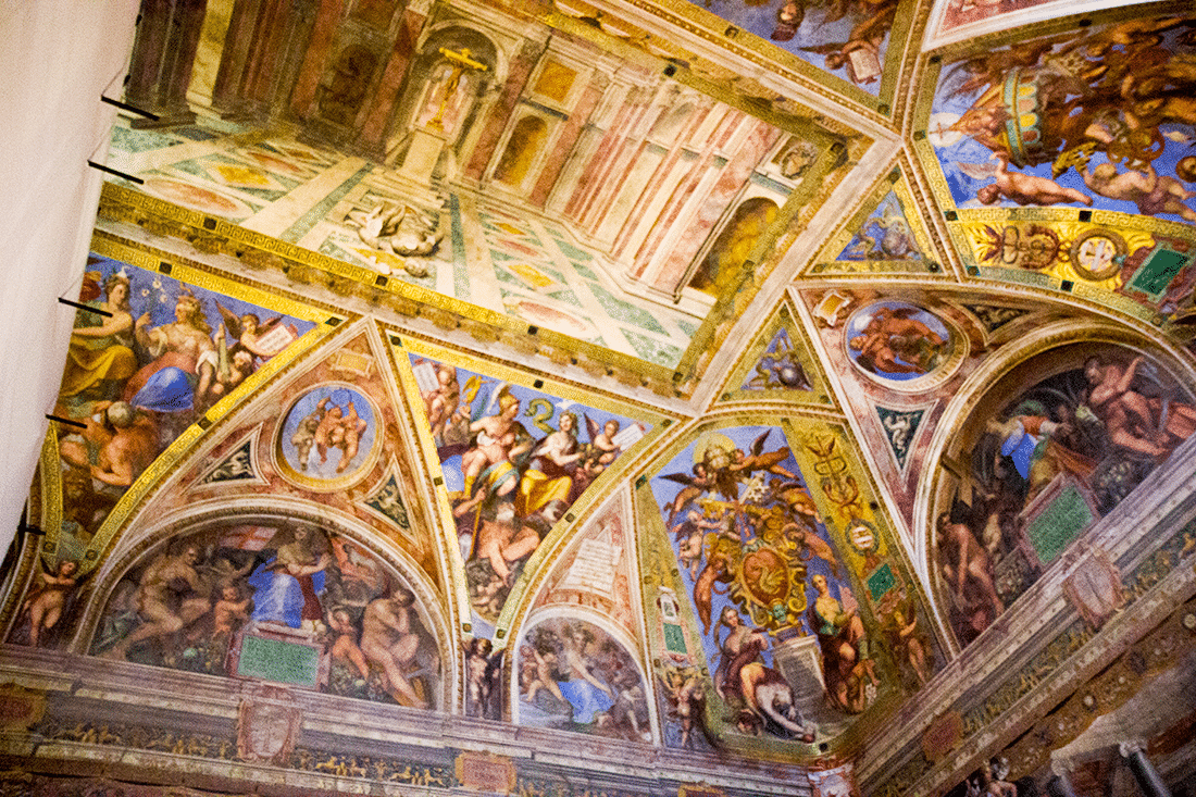 Visiting the Vatican in Rome, Italy. Ceiling details with paintings and gold leaf in the Vatican in Rome, Italy.