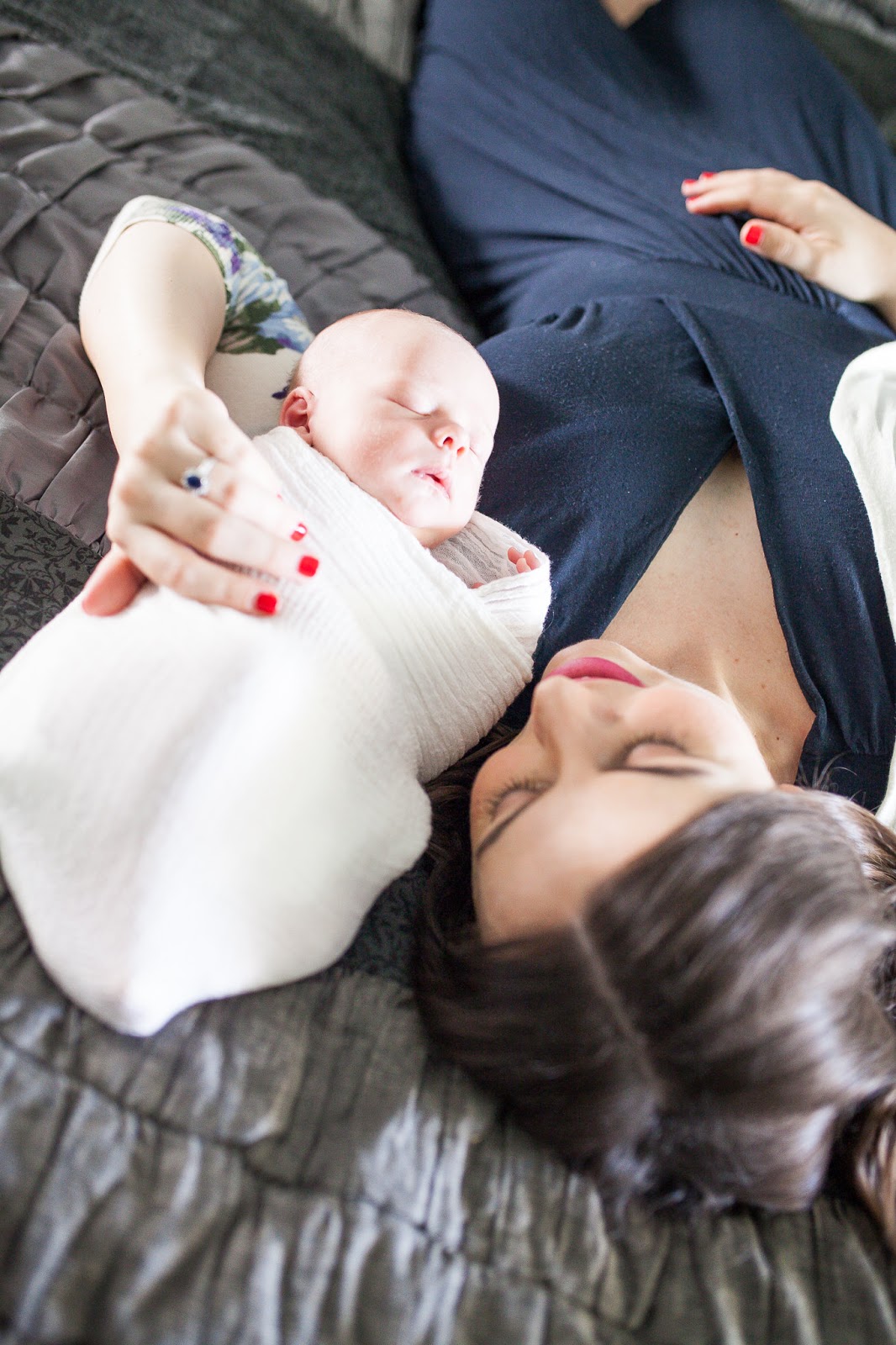 newborn baby with mom on a bed. 