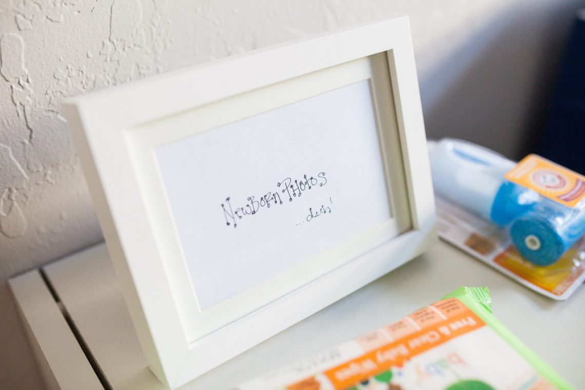 Newborn photos gift card in a picture frame. 
