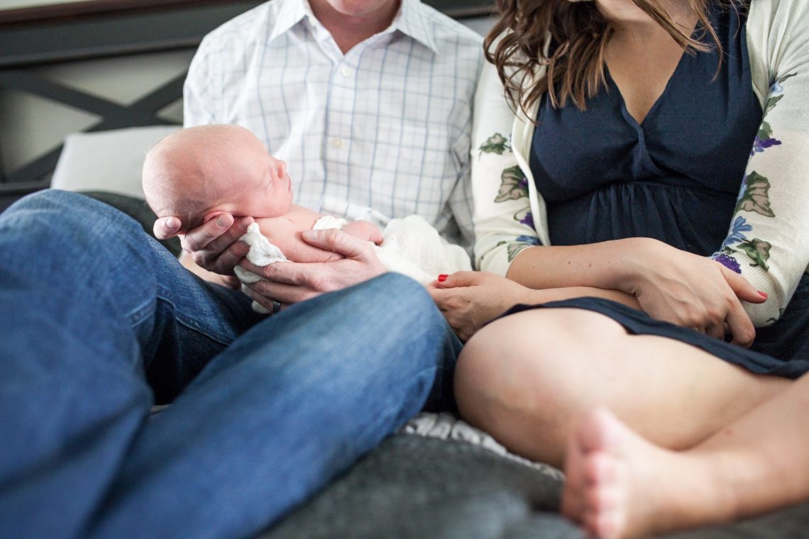 Newborn baby with parents for newborn photo shoot at home. 