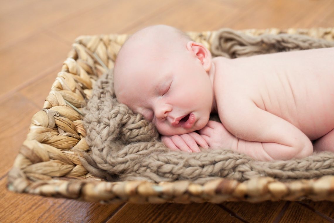 Newborn baby asleep during newborn photoshoot. 