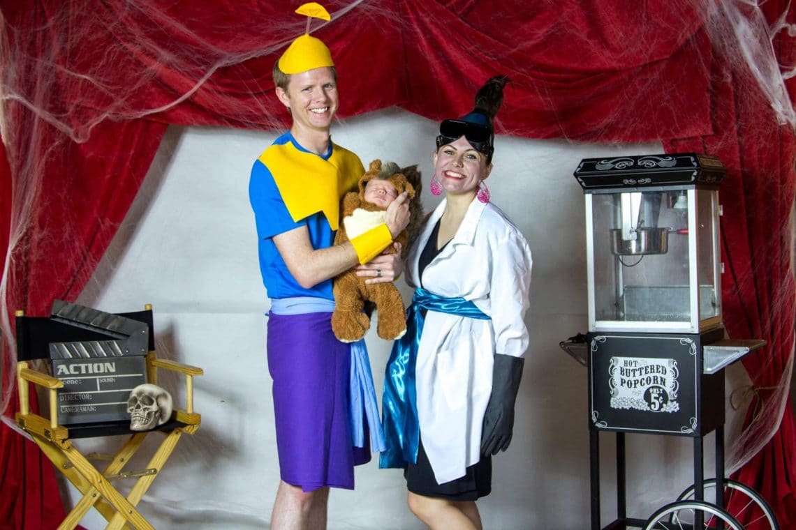 Emperor's New Groove family costume with dad as Gronk, mom as Yzma, and baby as Bucky the squirrel. 