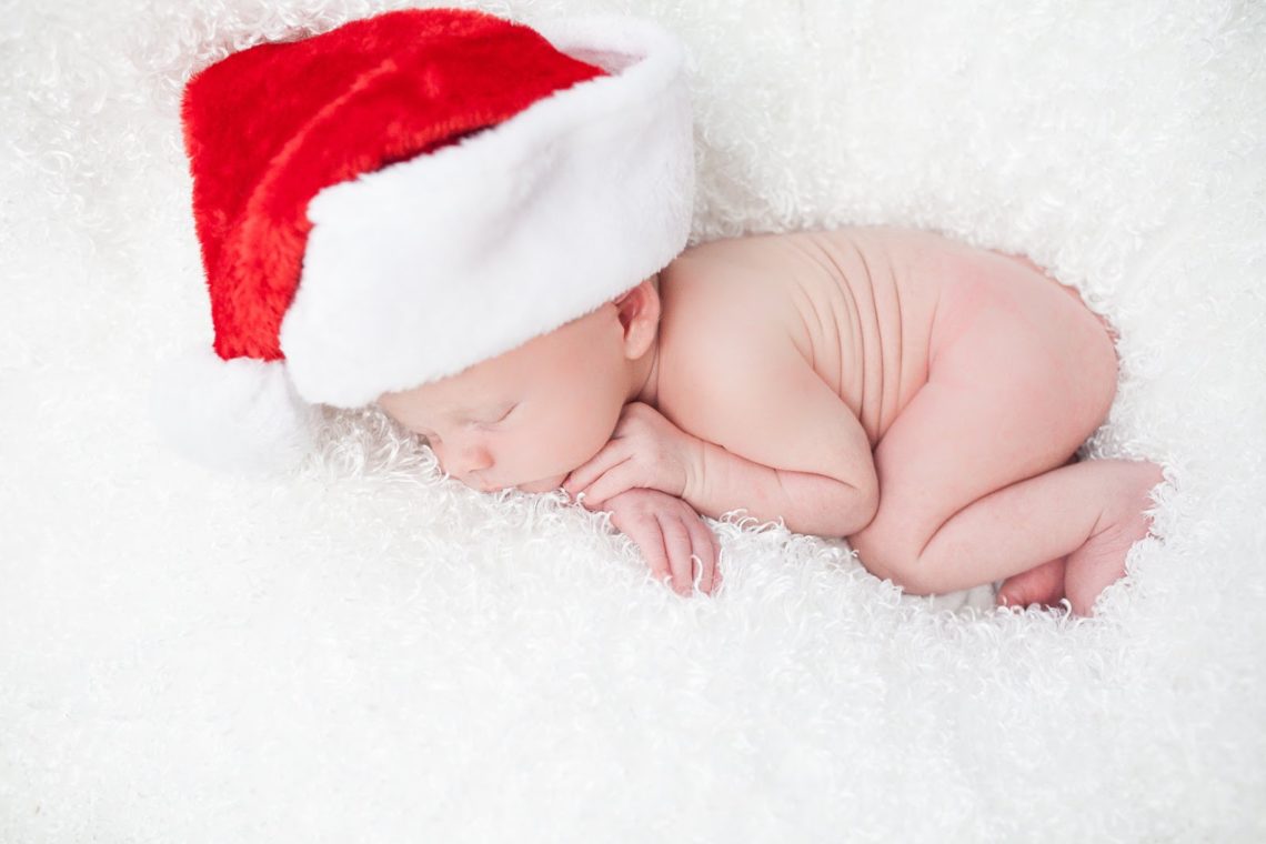Cute newborn photo with baby wearing a Santa hat. 
