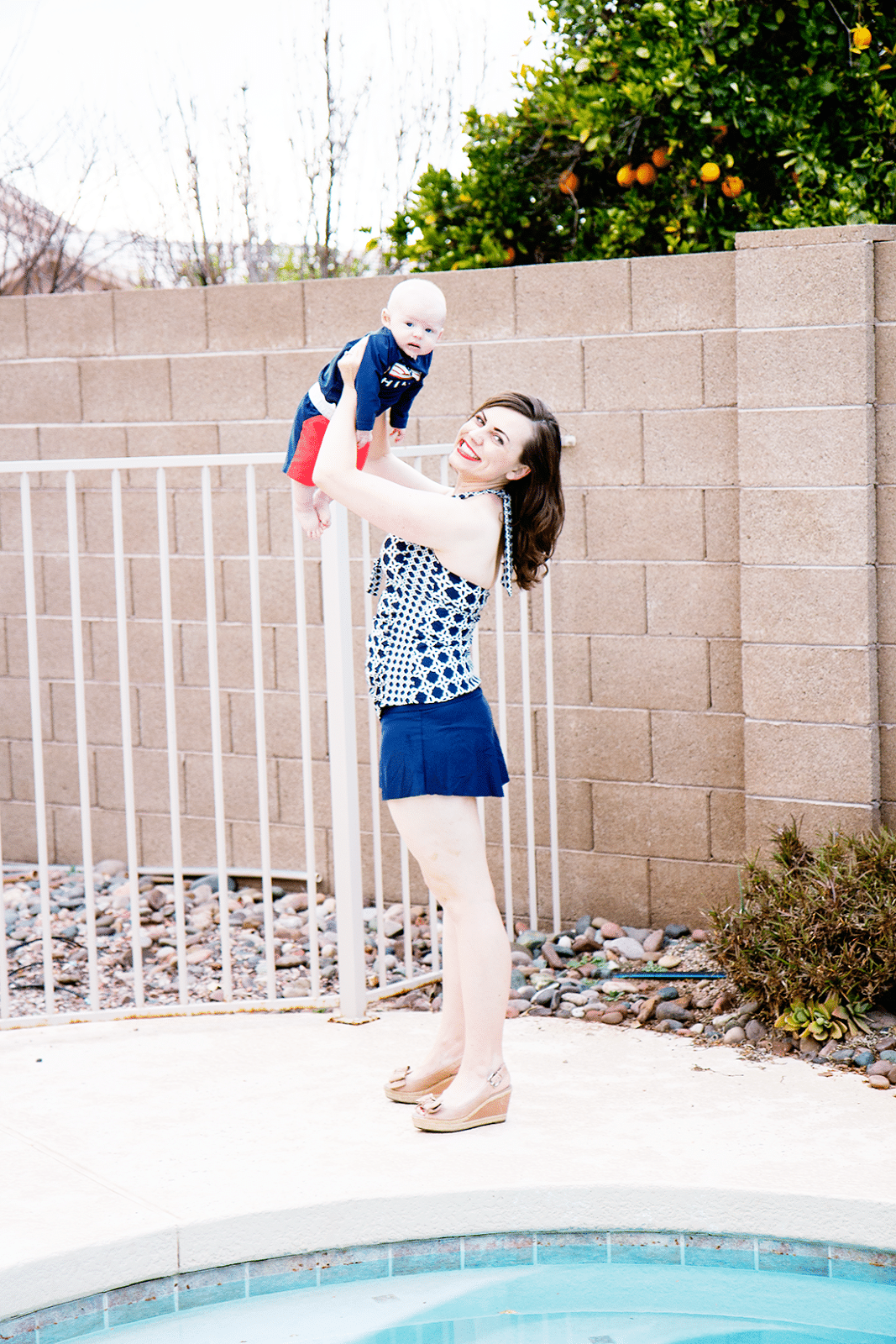 New mom in swimsuit holding her baby. 