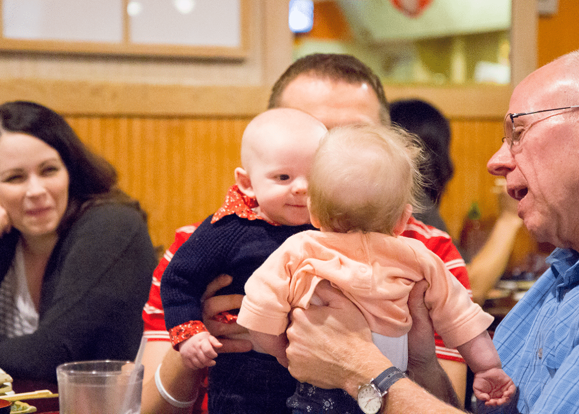 Two babies looking at each other. 