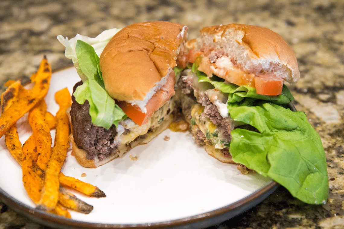 Jalapeno popper burger cut in half. 